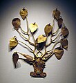 Gold hat ornament in the shape of an ox head with deer antlers with gold leaves