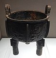 Bronze round tripod with animal mask decoration