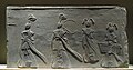 Brick relief depicting two scholars and two maids