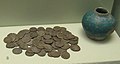 Pot hoard comprising 78 Persian silver coins in a small blue-glazed pot, from Sharjah in Trucial Oman, late 17th century.