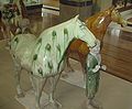 Two horses and a groom, made of brown, green glazed earthenware, from the tomb of Liu Tingxun (d. 728)