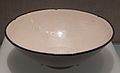 Ding ware white-glazed bowl impressed with scenes of wild geese flying through blossom