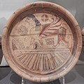 East Greek plate in the 'Wild Goat' style, showing a sphinx with geometric and floral motifs above a zone of petals. From Siana, Rhodes, 600-570 BC.