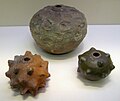 Three hollow pottery caltrops that would have been filled with gunpowder