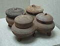 Four linked pottery jars