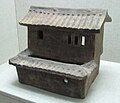 Glazed pottery model stilt house with carved design