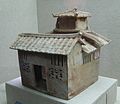 Pottery model building with a square courtyard and hip roof