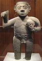 Stone figurine of a warrior holding a trophy head, from Costa Rica, AD 1000-1500.